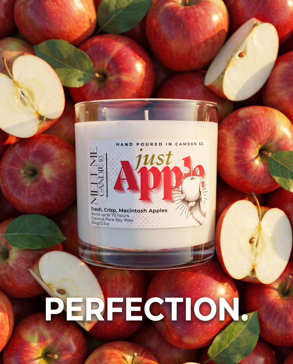 A clear glass jar candle labeled 'Just Apple' by Nellie's Candle Co., filled with white wax and placed among whole and sliced red apples with green leaves.