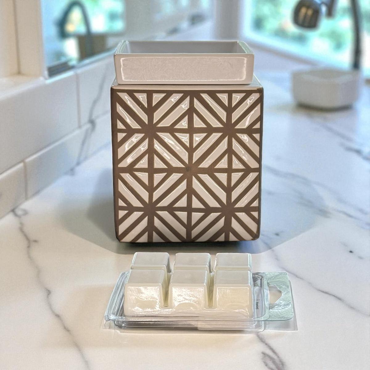 Decorative wax warmer with geometric design on a marble surface