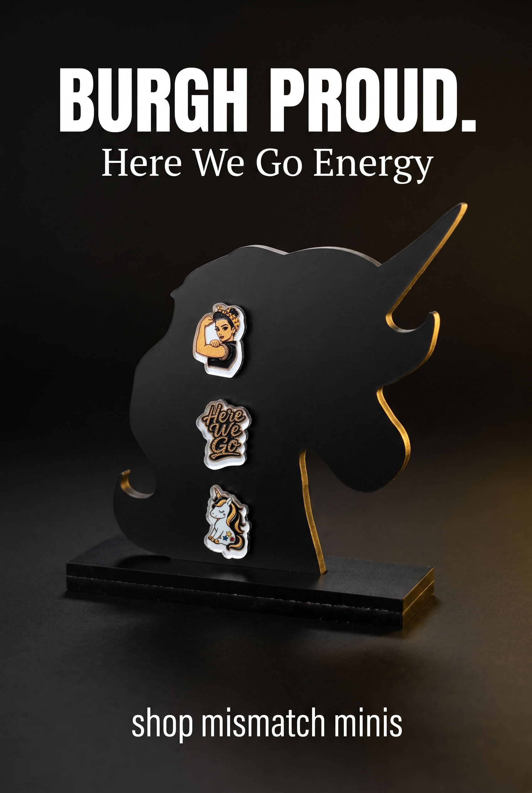 A black unicorn-shaped earring stand displaying three black-and-yellow acrylic stud earrings: a Rosie-inspired flexing woman, a 'Here We Go' design, and a unicorn, against a warm black-and-yellow promotional background.