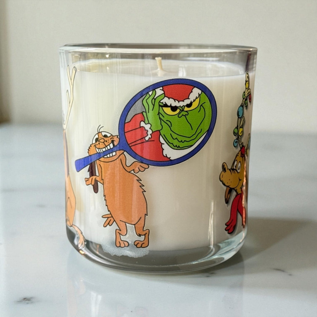 Candle with cartoon character design on a white surface