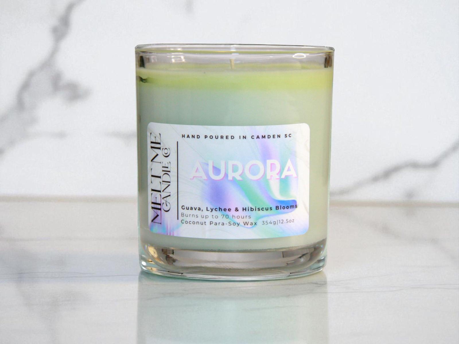 Candle labeled 'Aurora' with a colorful label on a marble surface