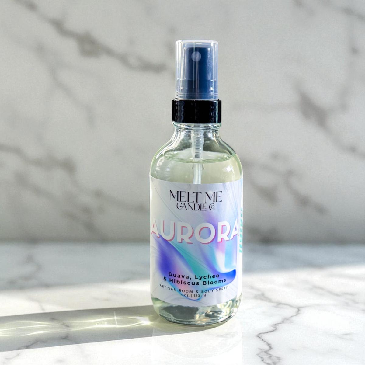 Bottle of 'Aurora' room and body spray by Melt Me Candle Co. on a marble surface with a marble background.