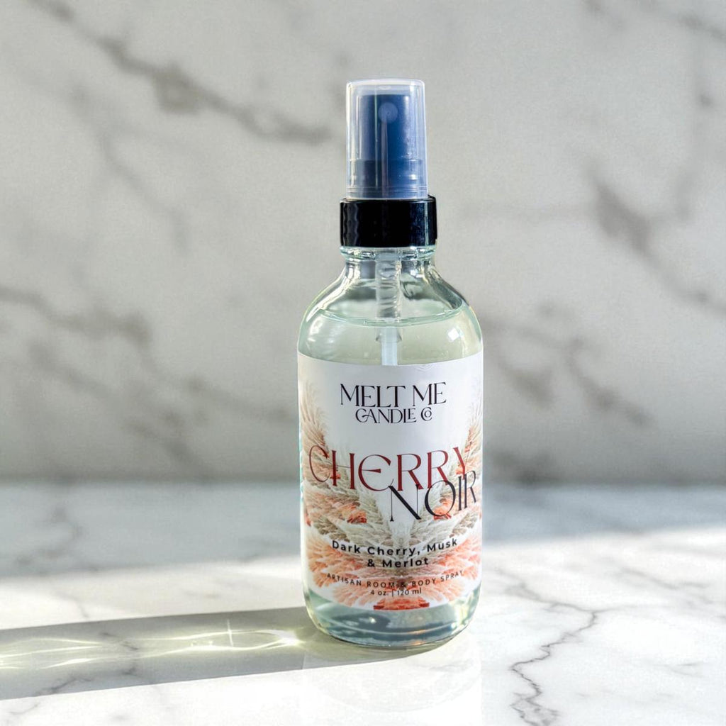 Bottle of 'Cherry Noir' spray on a marble surface with a marble background