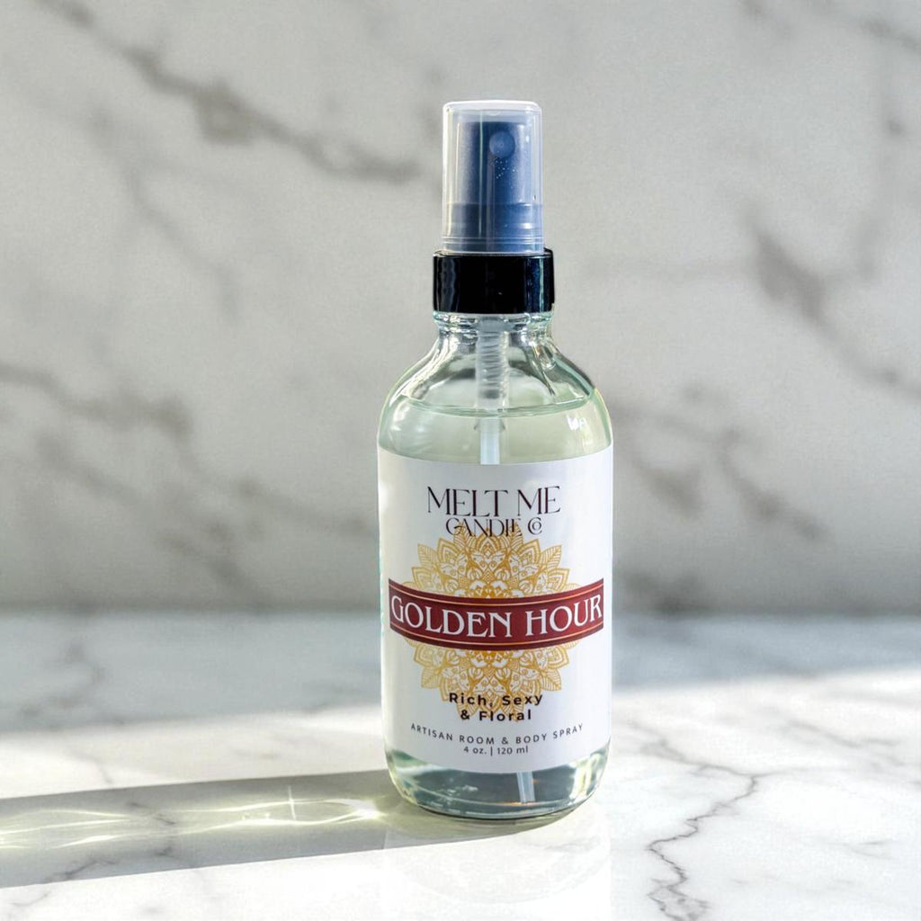 Bottle of 'Golden Hour' room and body spray by Melt Me Candle Co. on a marble surface with a marble background.