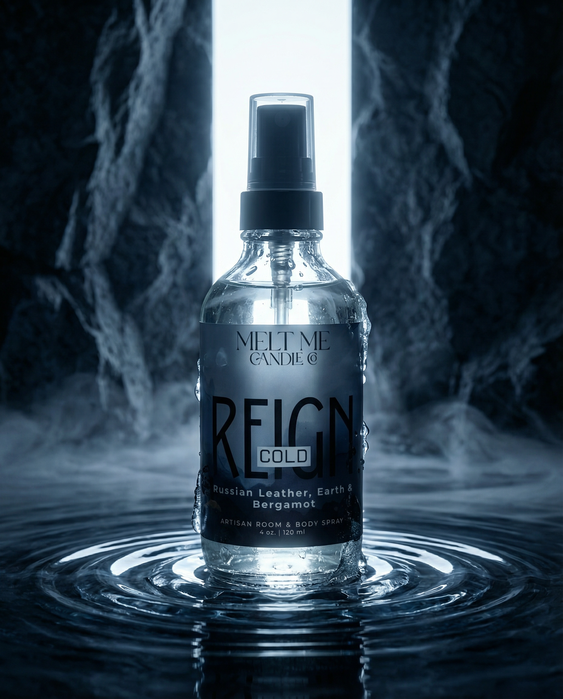 A clear glass spray bottle labeled 'Melt Me Candle Reign Cold' stands centered in rippling water, with a bright vertical light behind it and smoky dark blue surroundings.